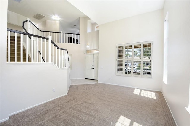 178 Grapevine Dr, Corona, CA 92882 - carpeted entrance foyer with a high ceiling, baseboards, and stairway