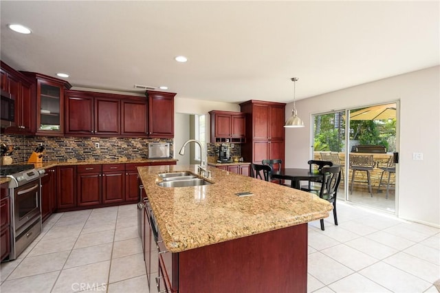 178 Grapevine Dr, Corona, CA 92882 - kitchen with reddish brown cabinets, stainless steel appliances, a sink, light tile patterned flooring, and recessed lighting