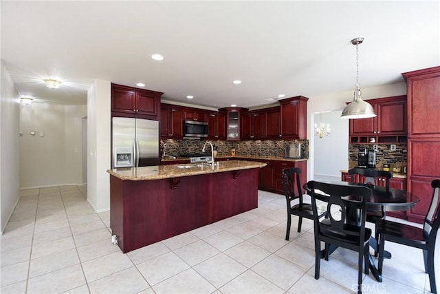 178 Grapevine Dr, Corona, CA 92882 - kitchen featuring appliances with stainless steel finishes, reddish brown cabinets, tasteful backsplash, light tile patterned floors, and recessed lighting