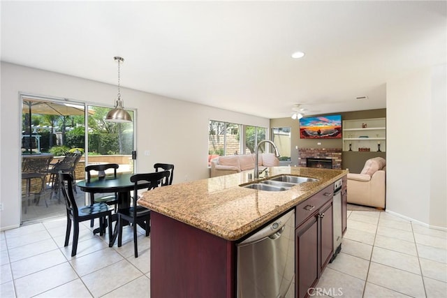 178 Grapevine Dr, Corona, CA 92882 - kitchen featuring a sink, dishwasher, a fireplace, a ceiling fan, and hanging light fixtures