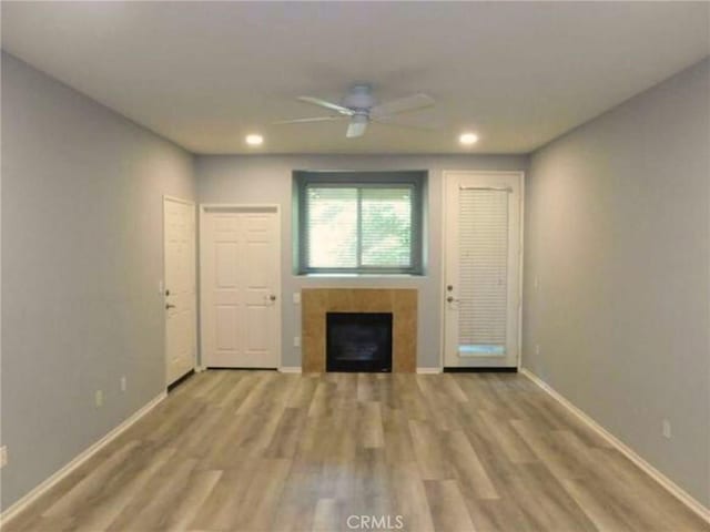 41410 Juniper St Unit 1513, Murrieta, CA 92562 - unfurnished living room featuring a fireplace, wood finished floors, recessed lighting, and a ceiling fan