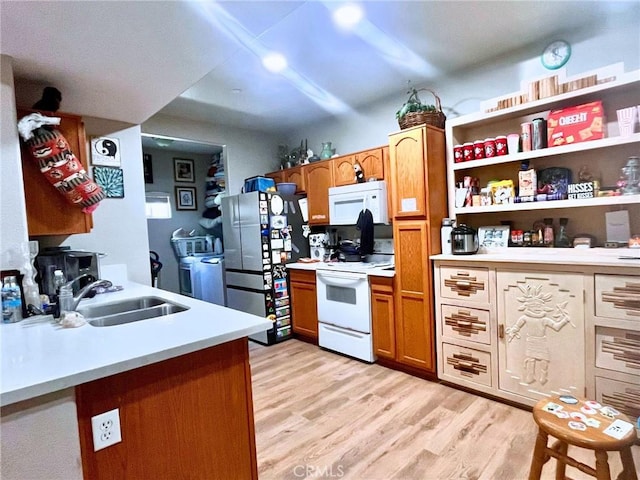 41410 Juniper St Unit 1513, Murrieta, CA 92562 - kitchen with white appliances, light countertops, light wood finished floors, and brown cabinetry