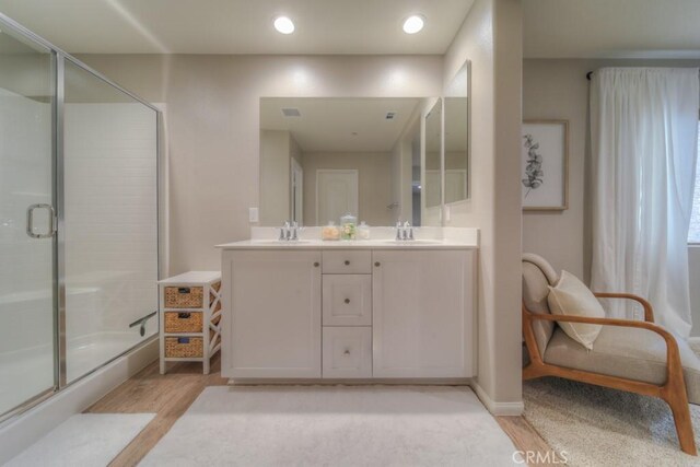 32593 Cumulus Ln, Winchester, CA 92596 - full bath with wood finished floors, a shower with door, double vanity, and baseboards