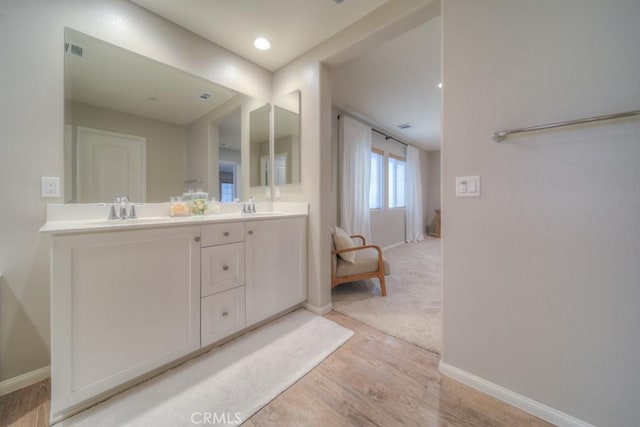 32593 Cumulus Ln, Winchester, CA 92596 - bathroom with double vanity, baseboards, and wood finished floors