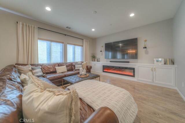 32593 Cumulus Ln, Winchester, CA 92596 - living area featuring light wood-style floors, recessed lighting, and a glass covered fireplace