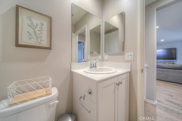 32593 Cumulus Ln, Winchester, CA 92596 - bathroom with toilet, vanity, and wood finished floors