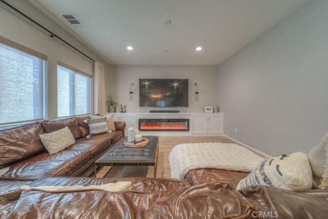 32593 Cumulus Ln, Winchester, CA 92596 - living area with wood finished floors, recessed lighting, and a glass covered fireplace