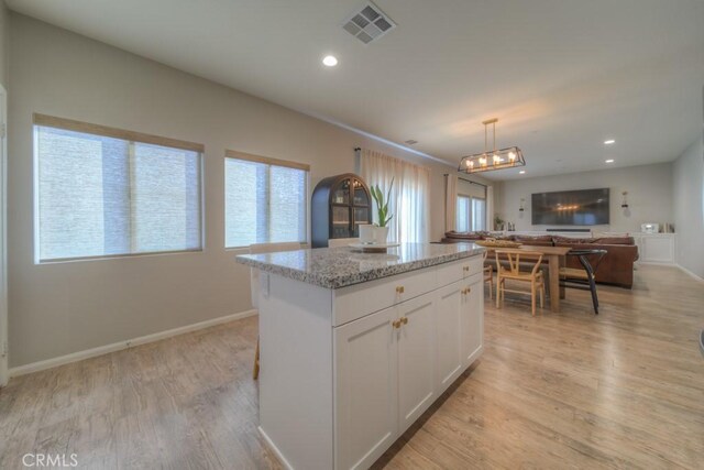32593 Cumulus Ln, Winchester, CA 92596 - kitchen with plenty of natural light, a center island, open floor plan, white cabinetry, and recessed lighting