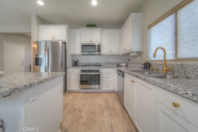 32593 Cumulus Ln, Winchester, CA 92596 - kitchen with stainless steel appliances, a sink, white cabinets, recessed lighting, and light wood finished floors