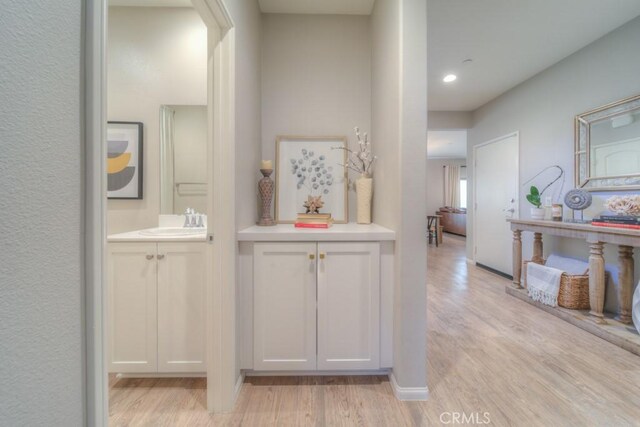 32593 Cumulus Ln, Winchester, CA 92596 - hallway with a sink, light wood finished floors, and recessed lighting