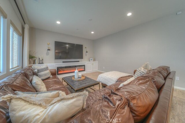 32593 Cumulus Ln, Winchester, CA 92596 - living area with light wood finished floors, recessed lighting, baseboards, and a glass covered fireplace