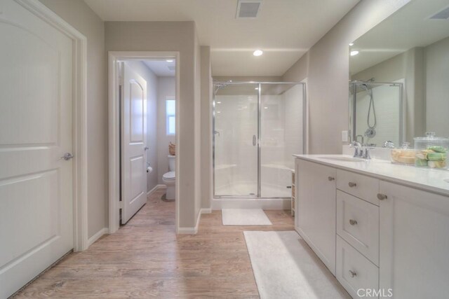 32593 Cumulus Ln, Winchester, CA 92596 - full bathroom with wood finished floors, a shower stall, toilet, and vanity