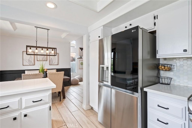 13492 Palomino Creek Dr, Corona, CA 92883 - kitchen featuring stainless steel fridge with ice dispenser, light countertops, white cabinets, tasteful backsplash, and hanging light fixtures