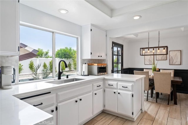 13492 Palomino Creek Dr, Corona, CA 92883 - kitchen featuring stainless steel microwave, light countertops, white cabinets, light wood finished floors, and recessed lighting