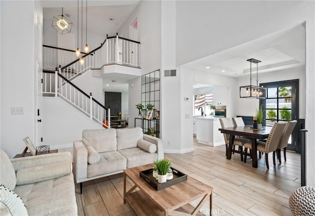 13492 Palomino Creek Dr, Corona, CA 92883 - living room featuring a chandelier, light wood-style floors, and stairway
