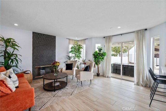 13492 Palomino Creek Dr, Corona, CA 92883 - living area featuring light wood-type flooring, recessed lighting, and a fireplace