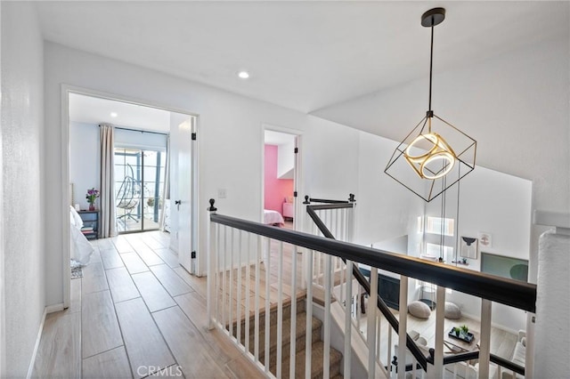 13492 Palomino Creek Dr, Corona, CA 92883 - hall with an upstairs landing, light wood-style flooring, recessed lighting, and a chandelier