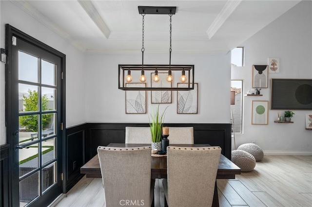 13492 Palomino Creek Dr, Corona, CA 92883 - dining space with a raised ceiling, light wood-type flooring, crown molding, and wainscoting