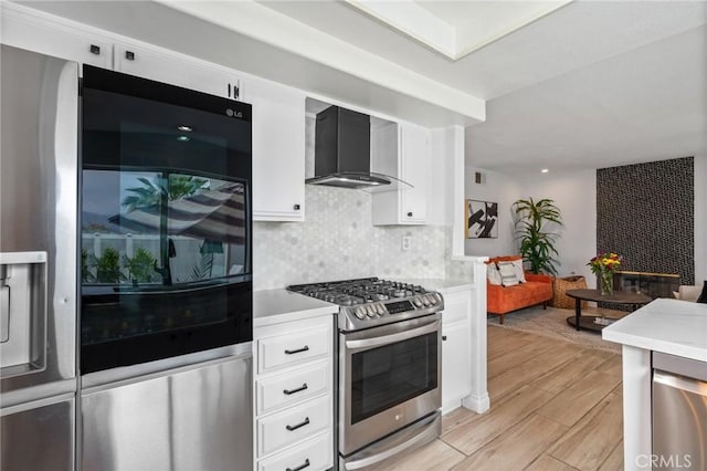 13492 Palomino Creek Dr, Corona, CA 92883 - kitchen with appliances with stainless steel finishes, wall chimney exhaust hood, light countertops, and light wood finished floors