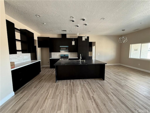 15640 Cheyenne Rd, Apple Valley, CA 92307 - kitchen with dark cabinetry, range, modern cabinets, a sink, and a textured ceiling