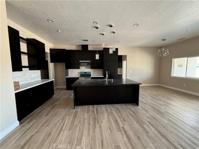 15640 Cheyenne Rd, Apple Valley, CA 92307 - kitchen with dark cabinetry, modern cabinets, stainless steel appliances, a textured ceiling, and tasteful backsplash