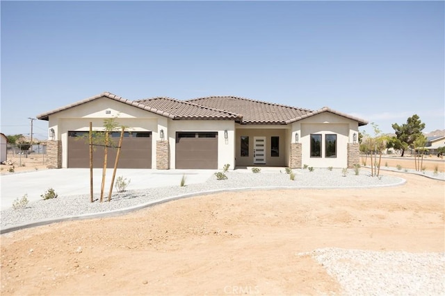 15640 Cheyenne Rd, Apple Valley, CA 92307 - view of front of house with stone siding, stucco siding, an attached garage, and a tiled roof
