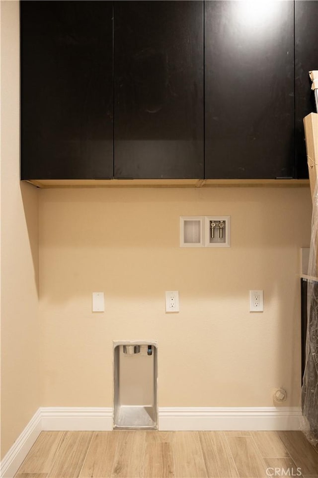 15640 Cheyenne Rd, Apple Valley, CA 92307 - laundry area with hookup for a washing machine, wood finished floors, cabinet space, and hookup for an electric dryer