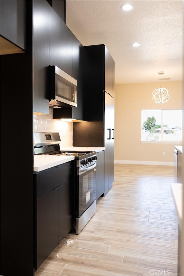 15640 Cheyenne Rd, Apple Valley, CA 92307 - kitchen with appliances with stainless steel finishes, dark cabinets, modern cabinets, tasteful backsplash, and recessed lighting