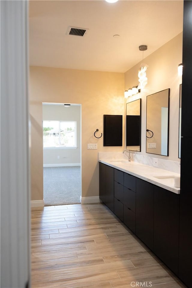 15640 Cheyenne Rd, Apple Valley, CA 92307 - bathroom with double vanity, wood finished floors, and a chandelier