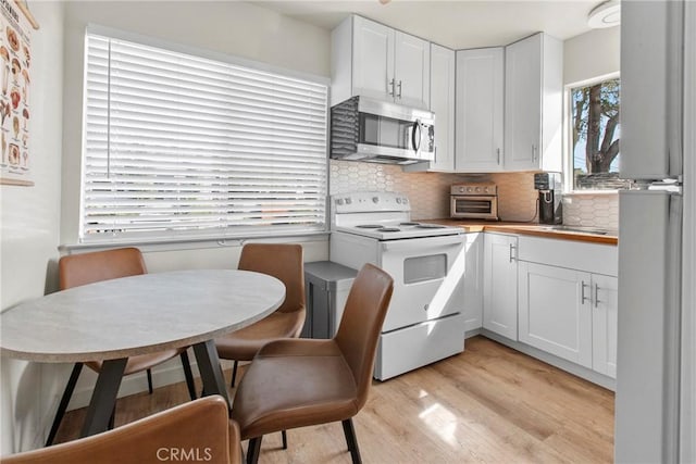 1022 Leff St, San Luis Obispo, CA 93401 - kitchen with stainless steel appliances, light wood finished floors, tasteful backsplash, and white cabinetry
