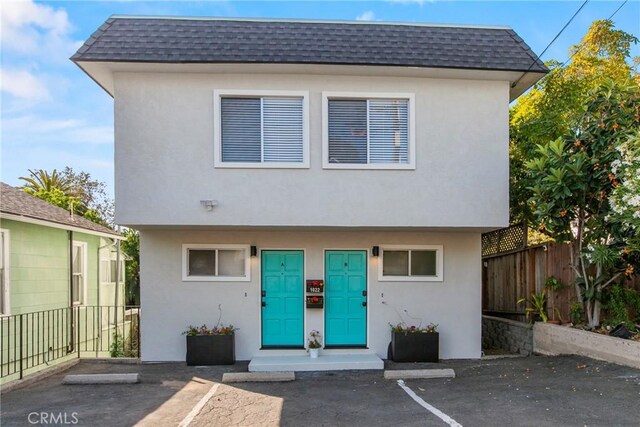 1022 Leff St, San Luis Obispo, CA 93401 - view of front of house featuring stucco siding, mansard roof, and uncovered parking
