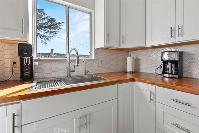 1022 Leff St, San Luis Obispo, CA 93401 - kitchen featuring butcher block countertops, a sink, and white cabinetry