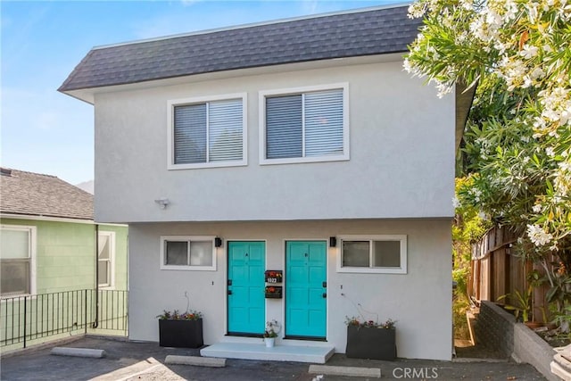 1022 Leff St, San Luis Obispo, CA 93401 - view of property with a shingled roof, stucco siding, and mansard roof