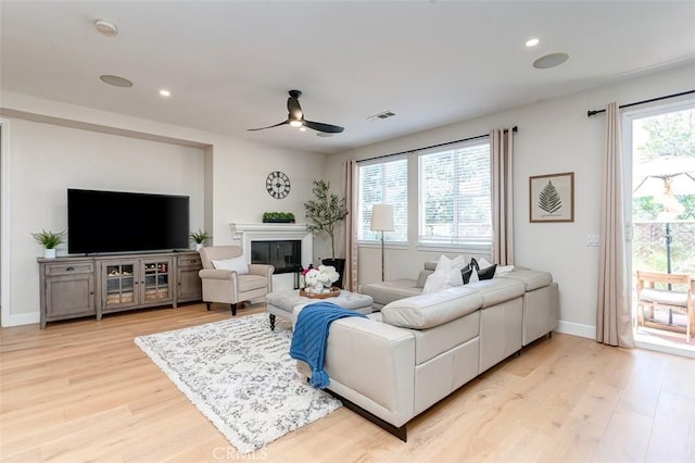 40365 Trenton Ct, Temecula, CA 92591 - living area featuring ceiling fan, light wood finished floors, a glass covered fireplace, and recessed lighting