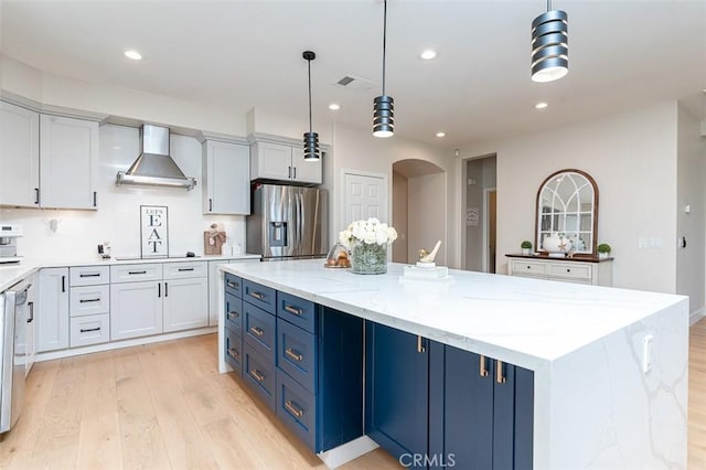 40365 Trenton Ct, Temecula, CA 92591 - kitchen featuring stainless steel refrigerator with ice dispenser, wall chimney exhaust hood, light wood-style flooring, blue cabinets, and a center island