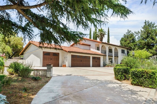 4527 Mockingbird Ln, Banning, CA 92220 - mediterranean / spanish house with a garage, a tiled roof, stucco siding, and driveway