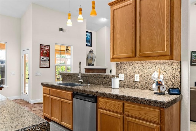 4802 Pentz Rd, Paradise, CA 95969 - kitchen with stainless steel dishwasher, a sink, backsplash, decorative light fixtures, and a peninsula