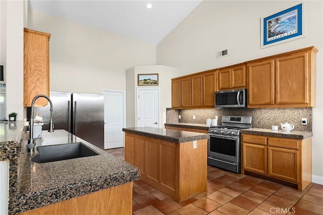 4802 Pentz Rd, Paradise, CA 95969 - kitchen featuring appliances with stainless steel finishes, a sink, a center island, tasteful backsplash, and high vaulted ceiling