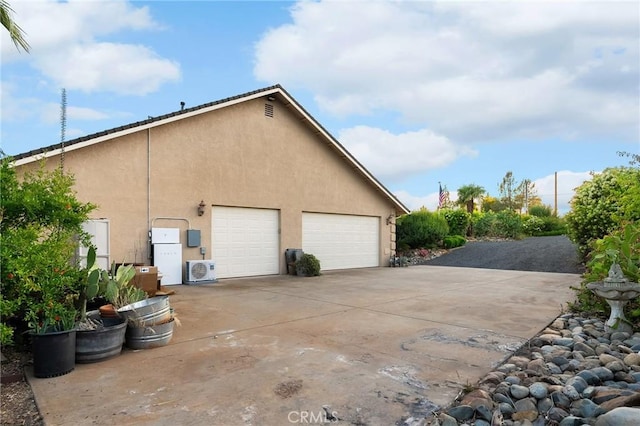 4802 Pentz Rd, Paradise, CA 95969 - view of property exterior featuring stucco siding, a garage, and a cooling unit