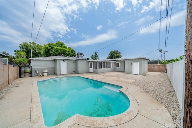 6622 Mitad Ct, San Bernardino, CA 92404 - back of property with a fenced backyard, a patio area, a gate, and stucco siding