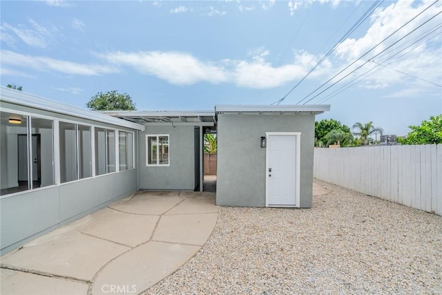 6622 Mitad Ct, San Bernardino, CA 92404 - rear view of house featuring stucco siding and a patio area