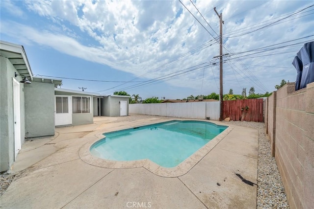 6622 Mitad Ct, San Bernardino, CA 92404 - view of pool featuring a patio area, a fenced backyard, and a sunroom