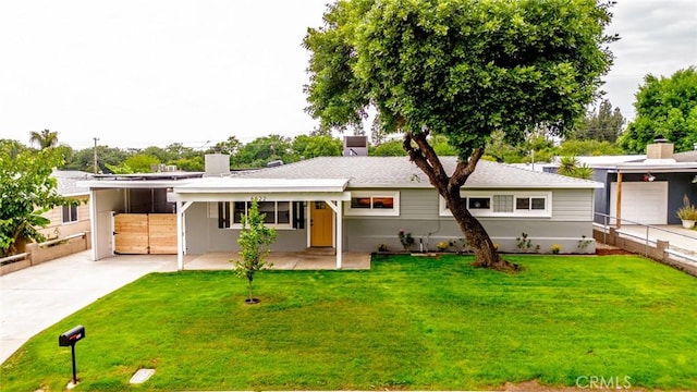 6622 Mitad Ct, San Bernardino, CA 92404 - ranch-style house with a chimney, driveway, and an attached carport