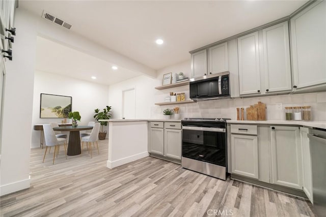 6622 Mitad Ct, San Bernardino, CA 92404 - kitchen featuring appliances with stainless steel finishes, light wood-style flooring, light countertops, recessed lighting, and tasteful backsplash
