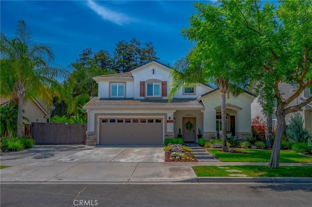 1122 Moonbeam Way, Turlock, CA 95382 - view of front facade featuring a garage, driveway, stone siding, stucco siding, and a tiled roof