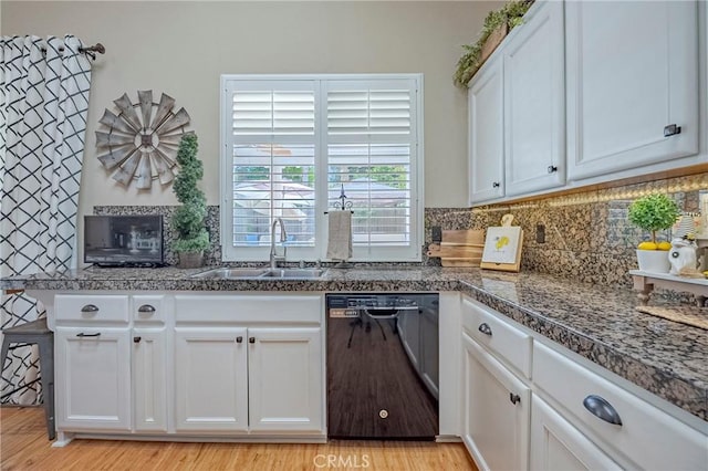 1122 Moonbeam Way, Turlock, CA 95382 - kitchen with black dishwasher, a sink, white cabinets, decorative backsplash, and light wood-style flooring