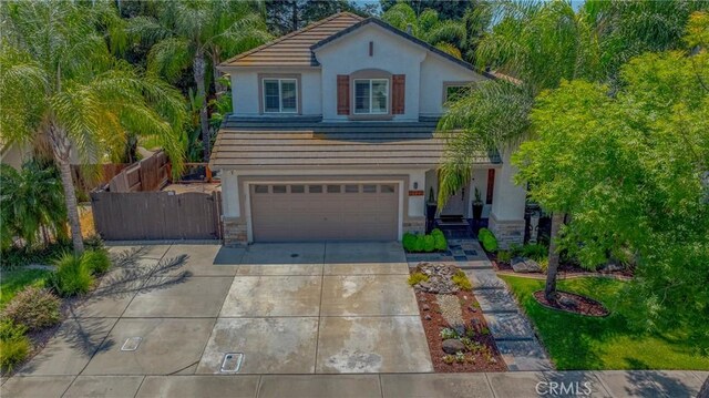 1122 Moonbeam Way, Turlock, CA 95382 - view of front of house with stucco siding, a tiled roof, concrete driveway, a garage, and stone siding