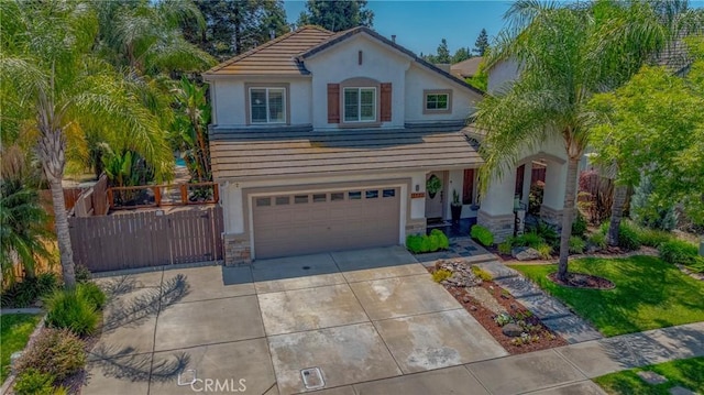 1122 Moonbeam Way, Turlock, CA 95382 - traditional-style house featuring stucco siding, a tiled roof, concrete driveway, and an attached garage