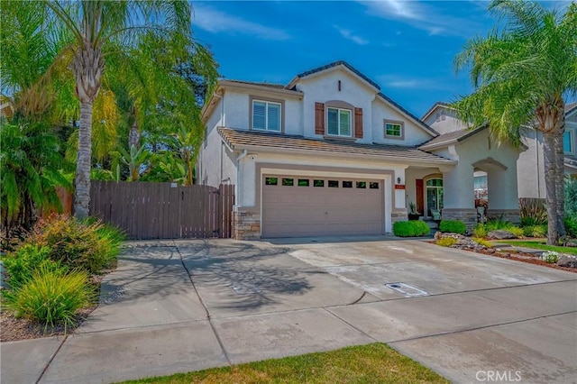 1122 Moonbeam Way, Turlock, CA 95382 - view of front facade featuring driveway, an attached garage, stucco siding, stone siding, and a tile roof