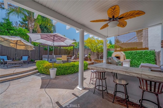 1122 Moonbeam Way, Turlock, CA 95382 - fenced backyard with an outdoor bar, a patio area, grilling area, and an outdoor hangout area